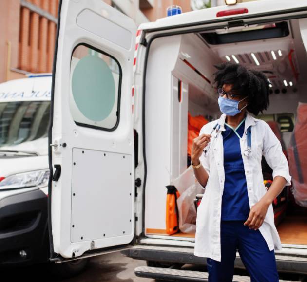 african-american-female-paramedic-face-protective-medical-mask-standing-front-ambulance-car